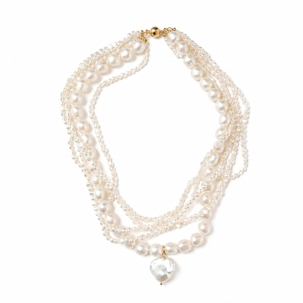 A multi-strand pearl necklace featuring a baroque pearl pendant with a gold clasp, displayed on a clean white background.
