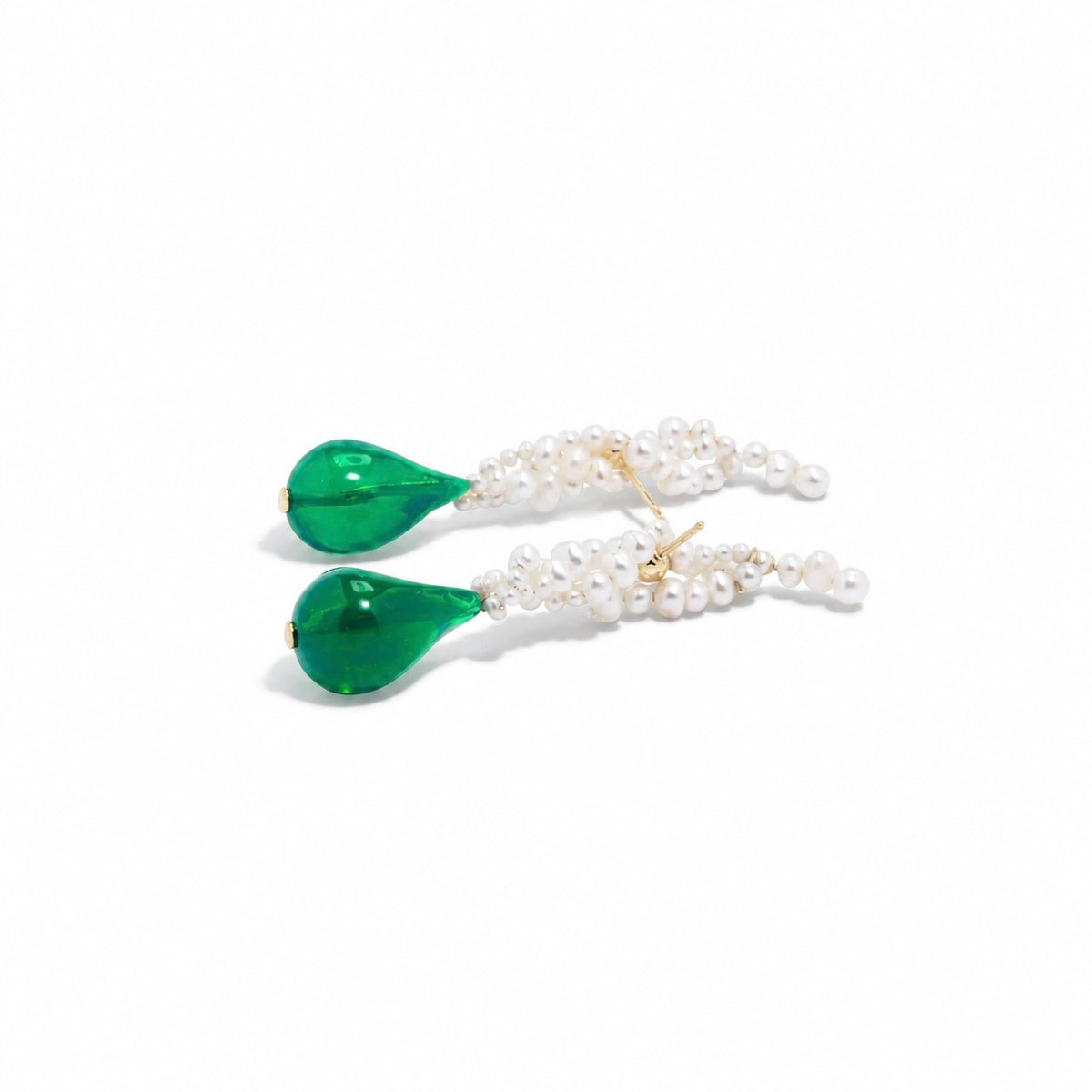 A pair of gold dangle earrings featuring a cluster of small white pearls at the top and a large, organic-shaped green teardrop gemstone at the bottom, set against a plain white background.