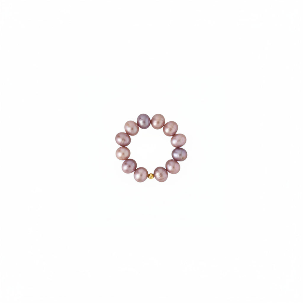 A beaded stretch bracelet made of irregular freshwater pearls in shades of light purple, displayed on a solid white background.