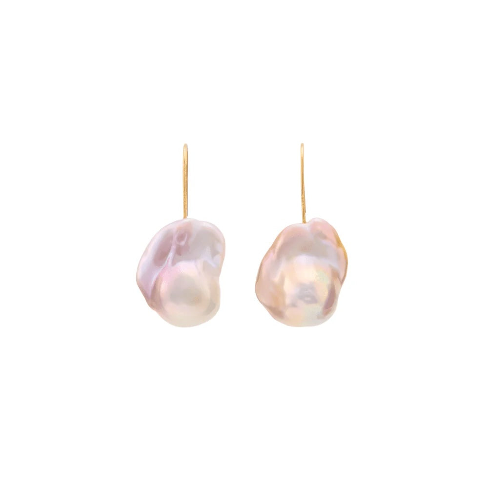 A pair of pink-toned baroque pearl drop earrings with gold hooks, displayed against a solid white background.