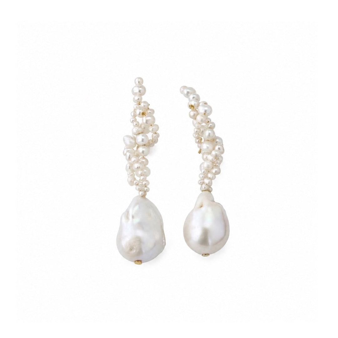 A pair of baroque pearl drop earrings with curved clusters of small white pearls leading down to larger irregular white pearl drops, shown on a plain white background.