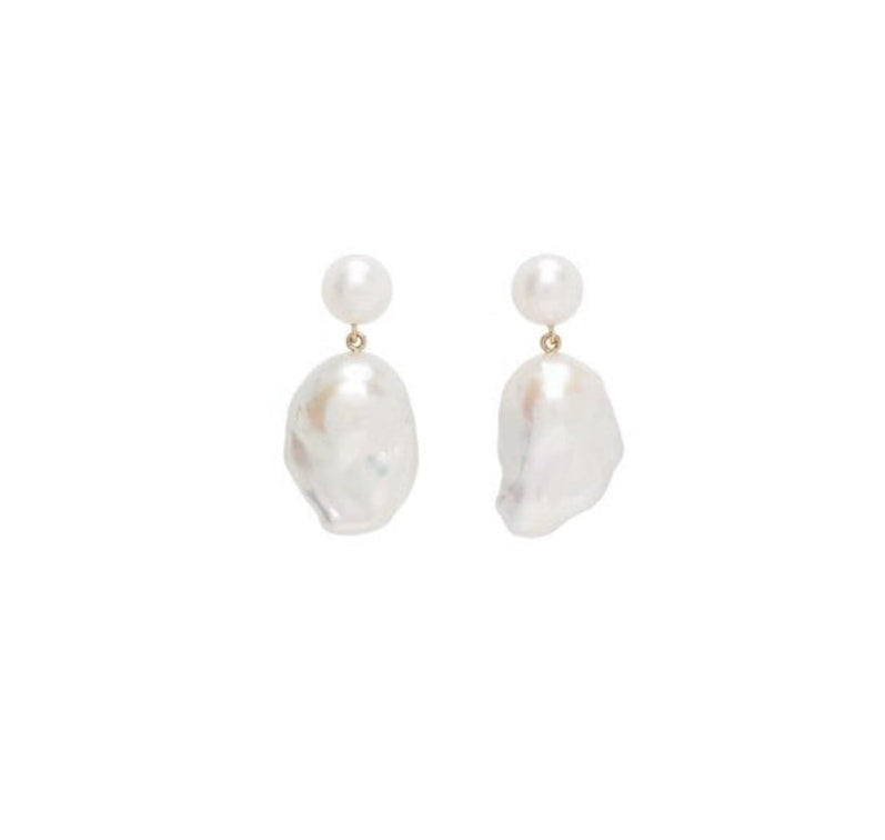 A pair of baroque pearl drop earrings with a small white pearl stud and an irregular white baroque pearl drop, suspended from gold-toned rings, shown on a plain white background.