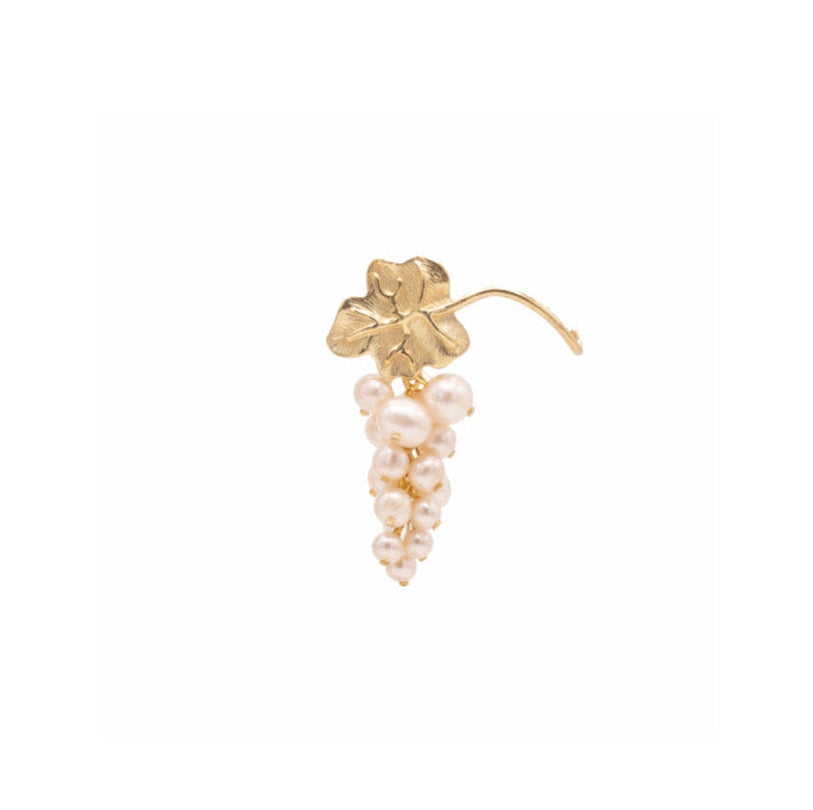 An earring with a gold vine leaf shape with a pearl cluster attached below, shown in white background.