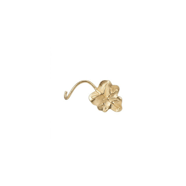 A small gold-toned metal charm shaped like a four-leaf clover with a curved hook extending from one side, shown on a plain white background.