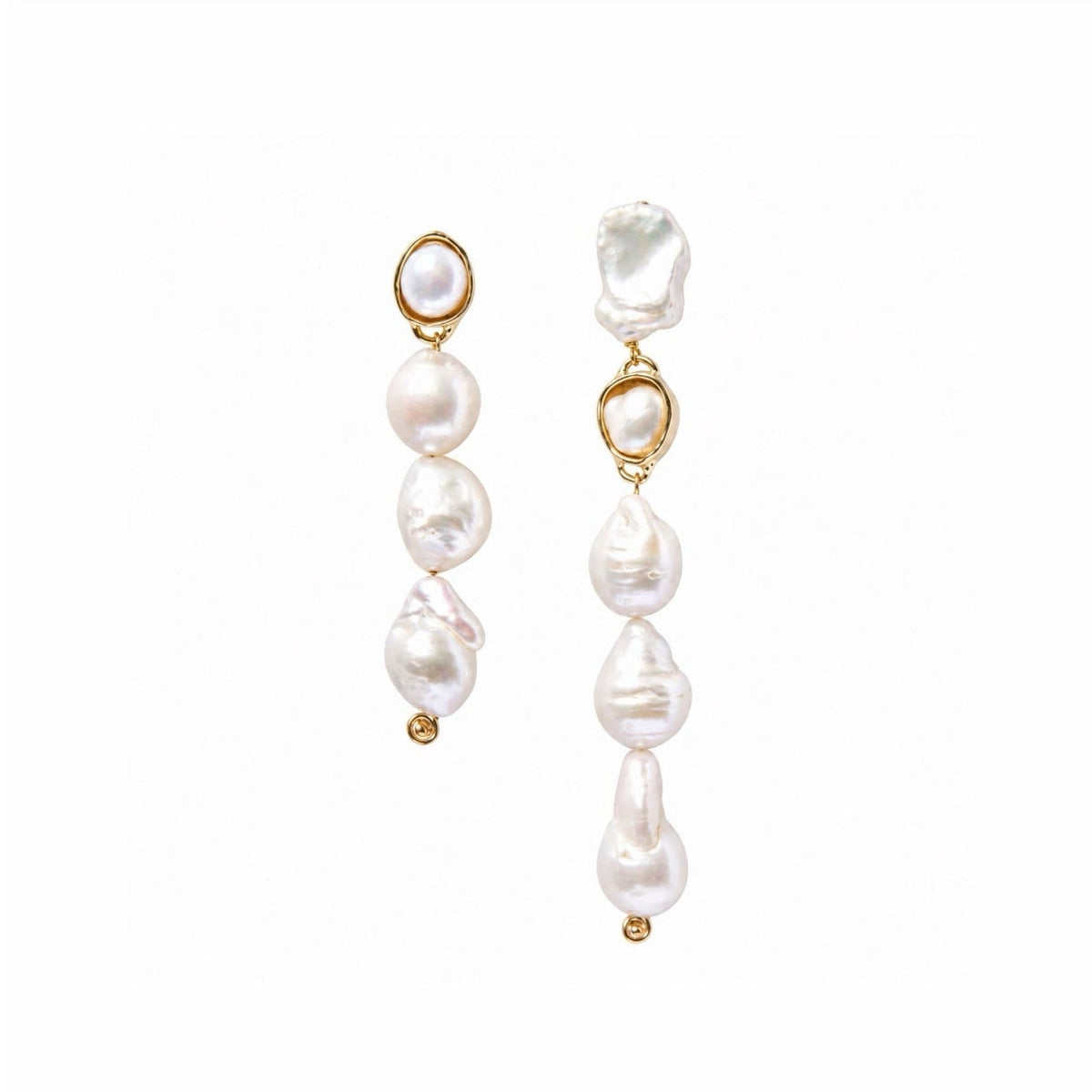 A pair of gold and baroque pearl dangle earrings on a solid white background.