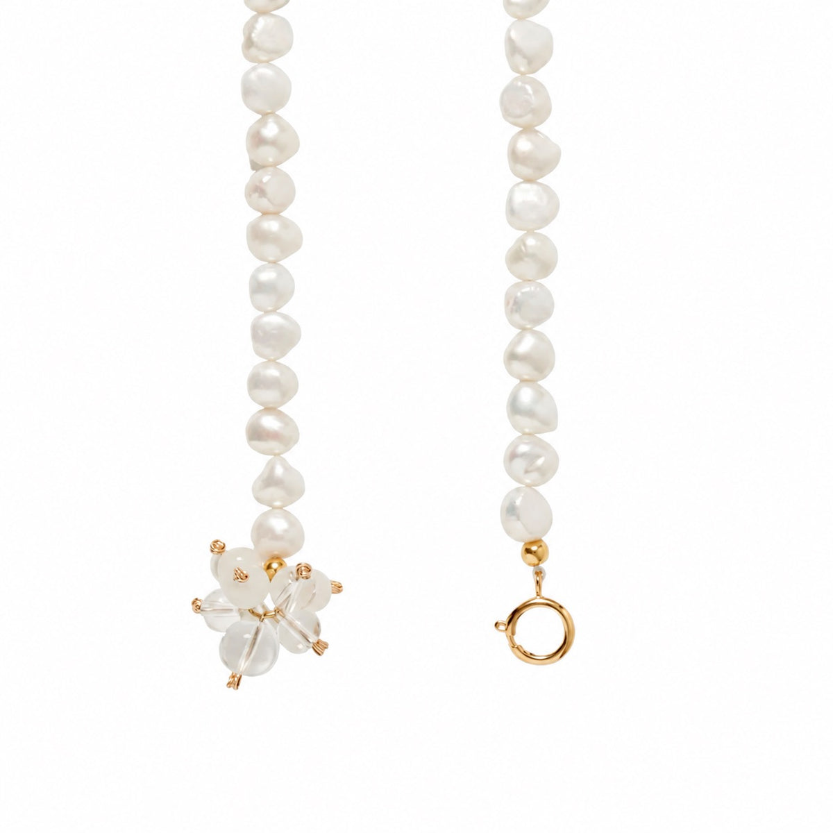 Two ends of a pearl beaded belt. One end with a clear quartz gemstone cluster charm and the other end with a golden clasp. Shown in a white background.